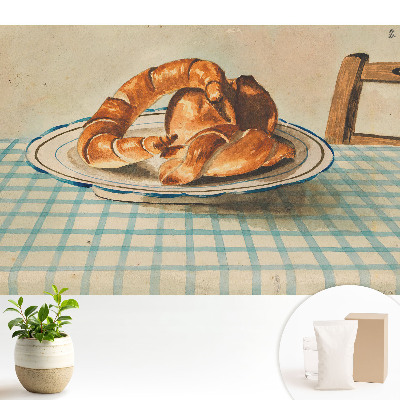 Croissant-ok egy tányéron egy kockás asztalnál