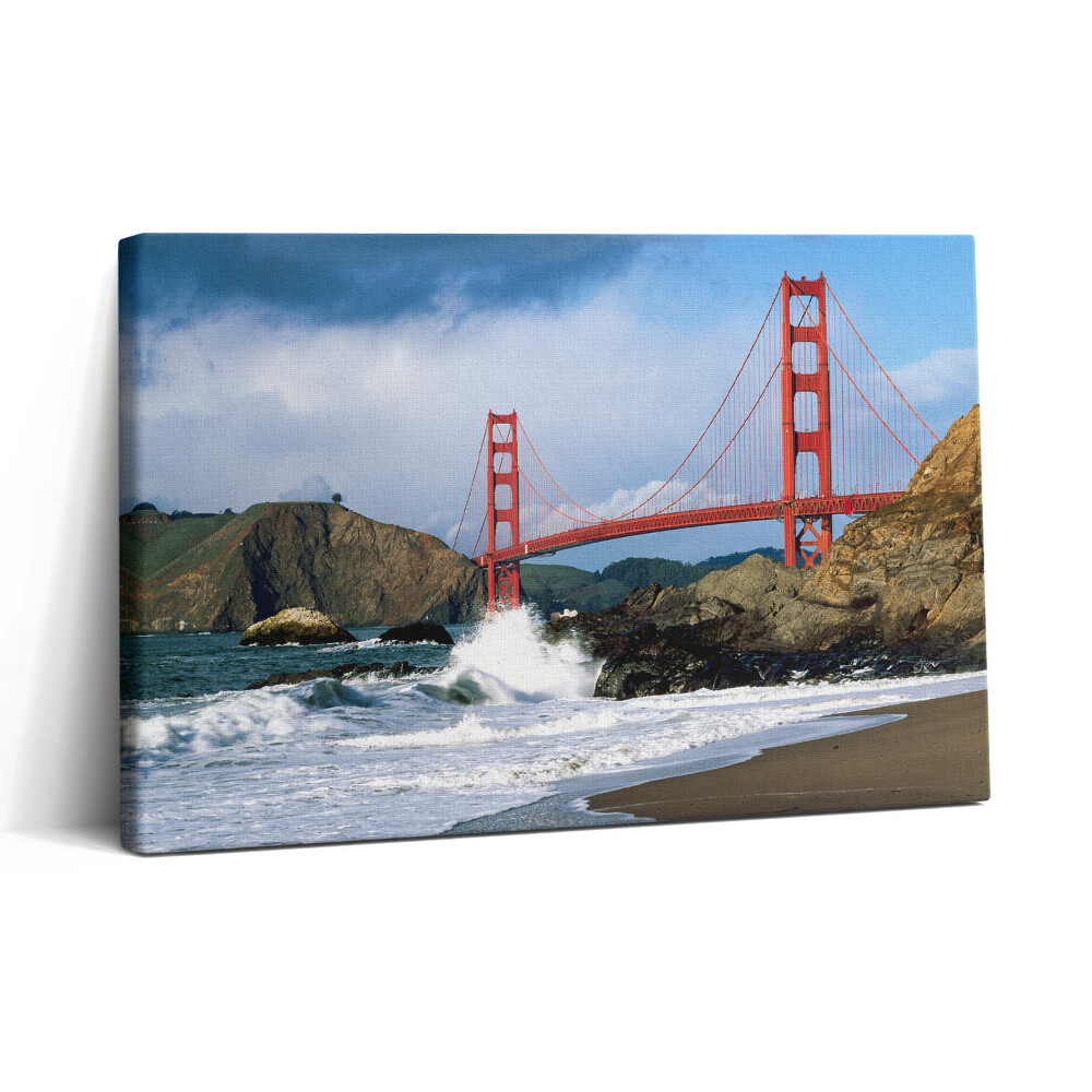 Vászonkép nyomtatás 30x20 Hullámok a tengerparton és egy piros híd