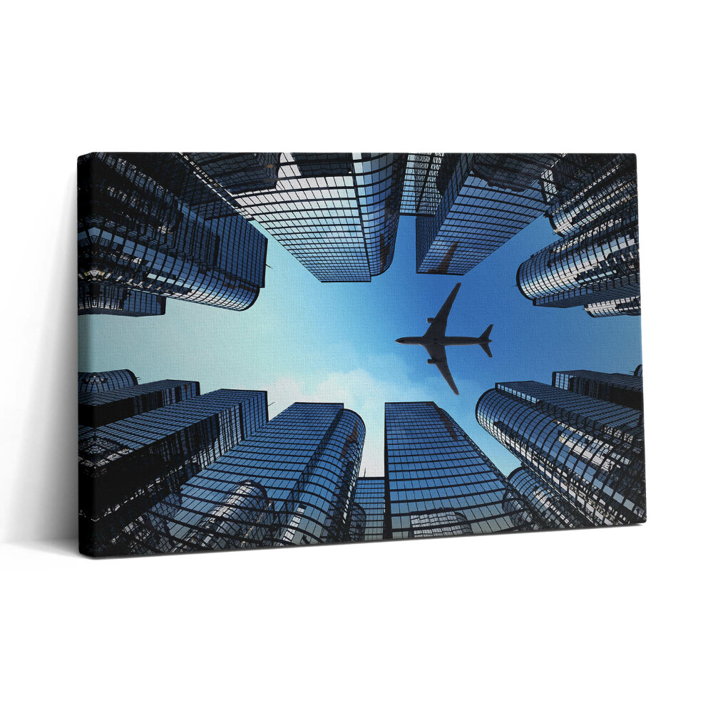 Vászonkép nyomtatás 30x20 Repülőgép az épületek felett