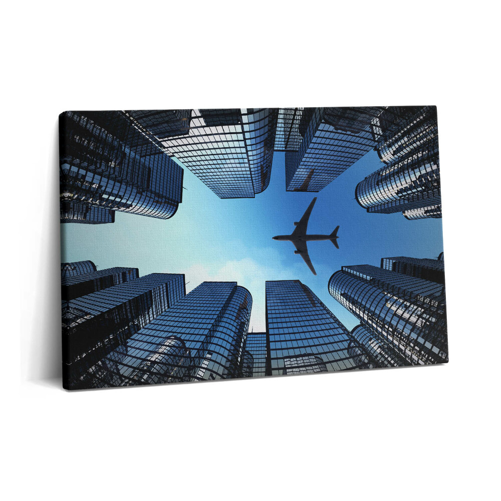 Canvas kép 60x40 Repülőgép az épületek felett