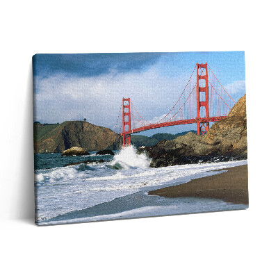 Vászonkép falra 80x60 Hullámok a tengerparton és egy piros híd
