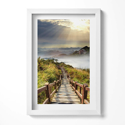 Keretezett kép Fakorlátos lépcső egy hegyvidéki tájon