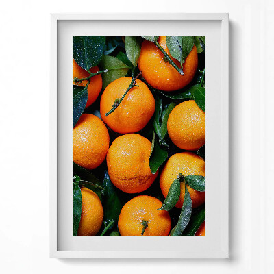 Függőleges kép keretben Friss narancsok zöld levelekkel