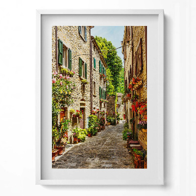 Függőleges kép keretben Szűk virágokkal díszített utcácska